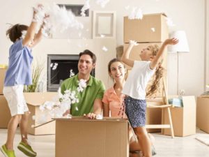 Family Unpacking Cardboard Box